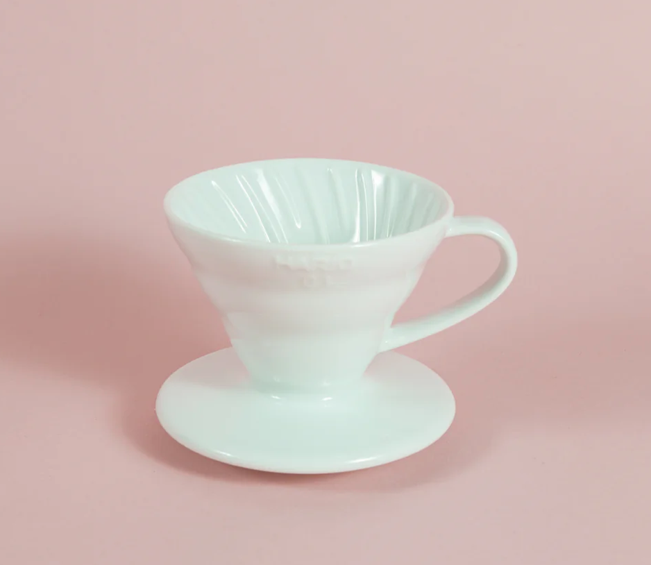 White ceramic coffee filter on a pink background